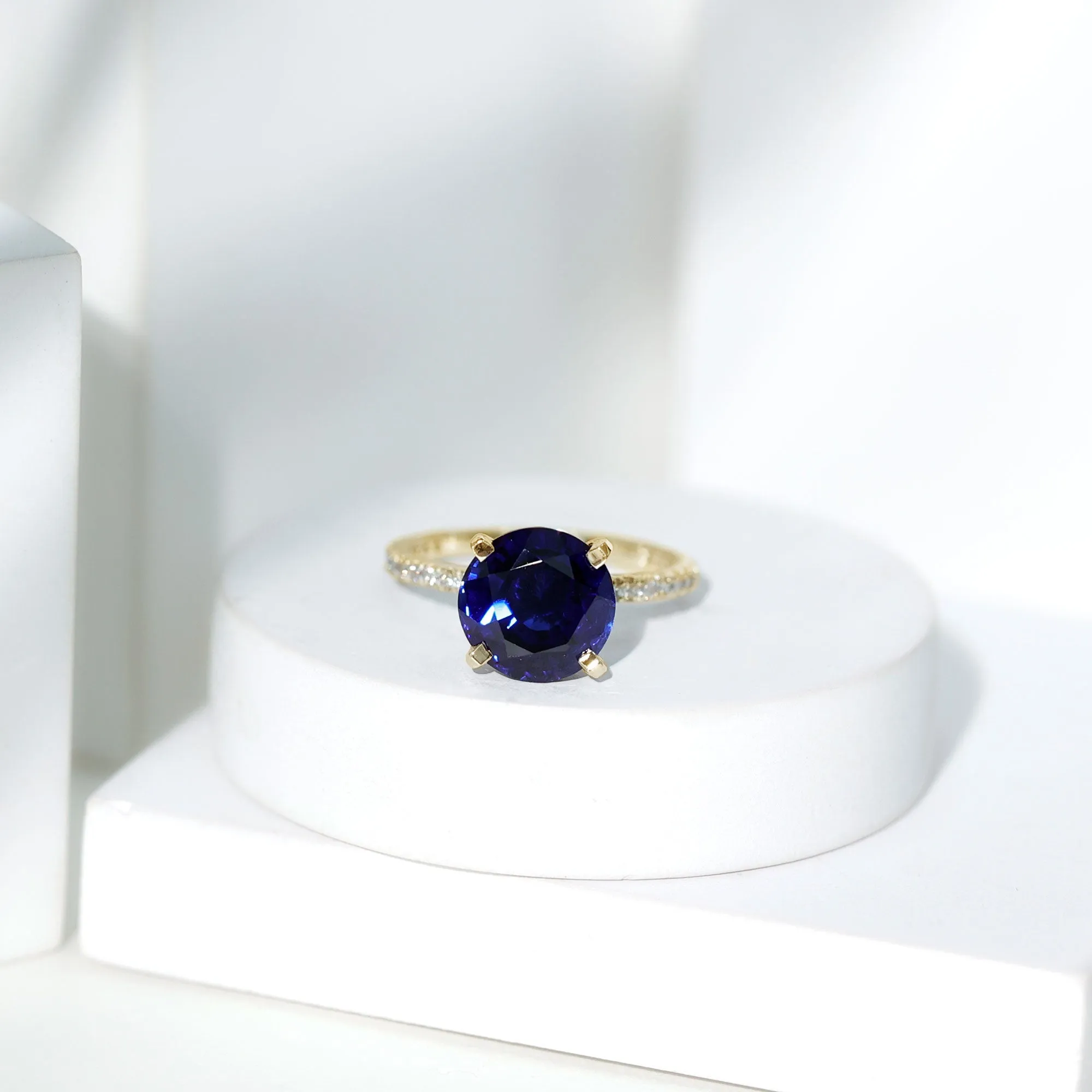 Created Blue Sapphire Solitaire Ring with Diamond Side Stones